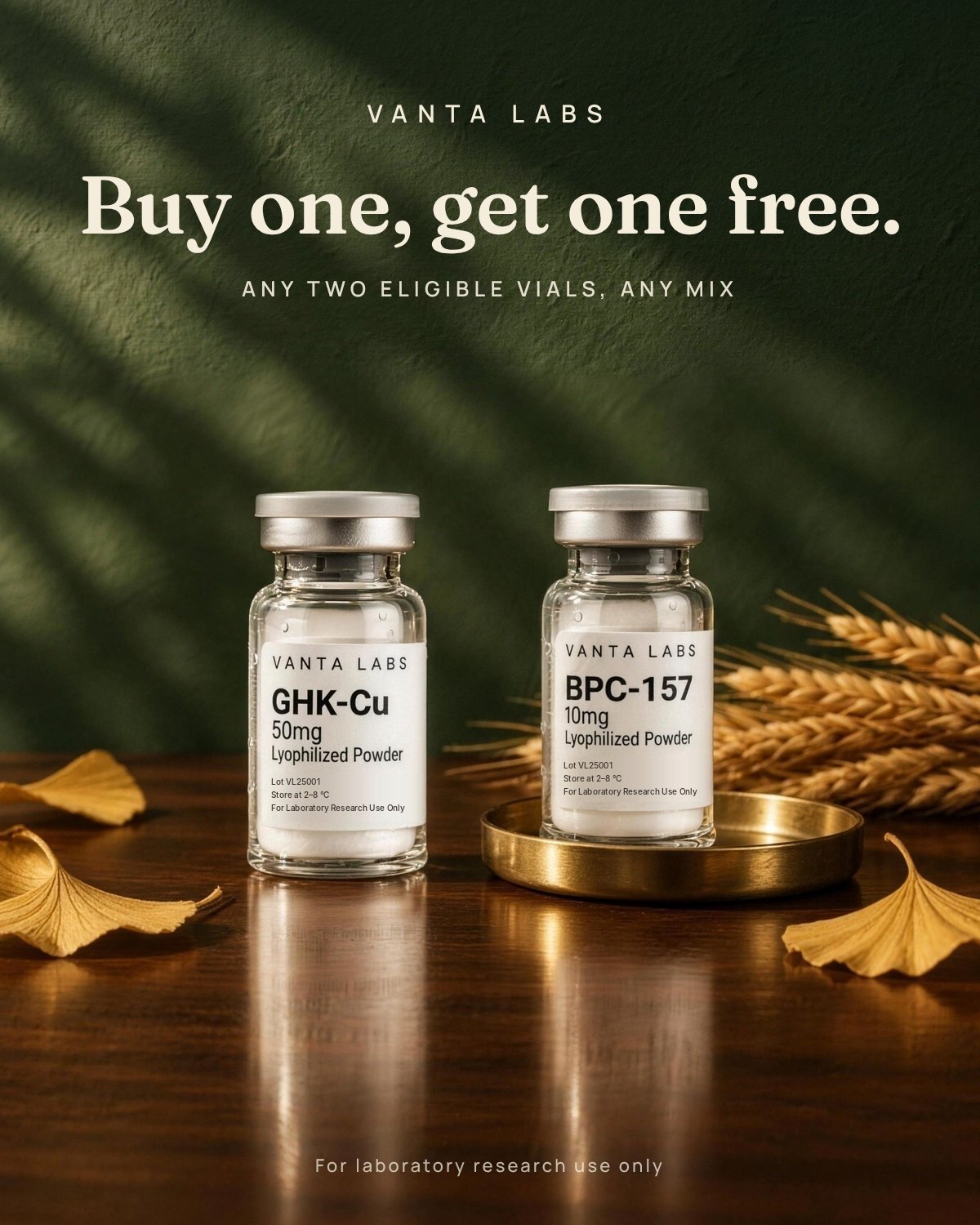 Buy one, get one free: BPC-157 and GHK-Cu vials on a walnut table with golden ginkgo leaves
